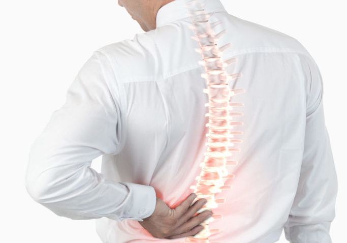 Digital composite of Highlighted spine of man with back pain